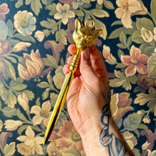 A detailed close-up of the Brass Fox Letter Opener, showcasing the intricately sculpted fox head handle and polished golden brass finish.