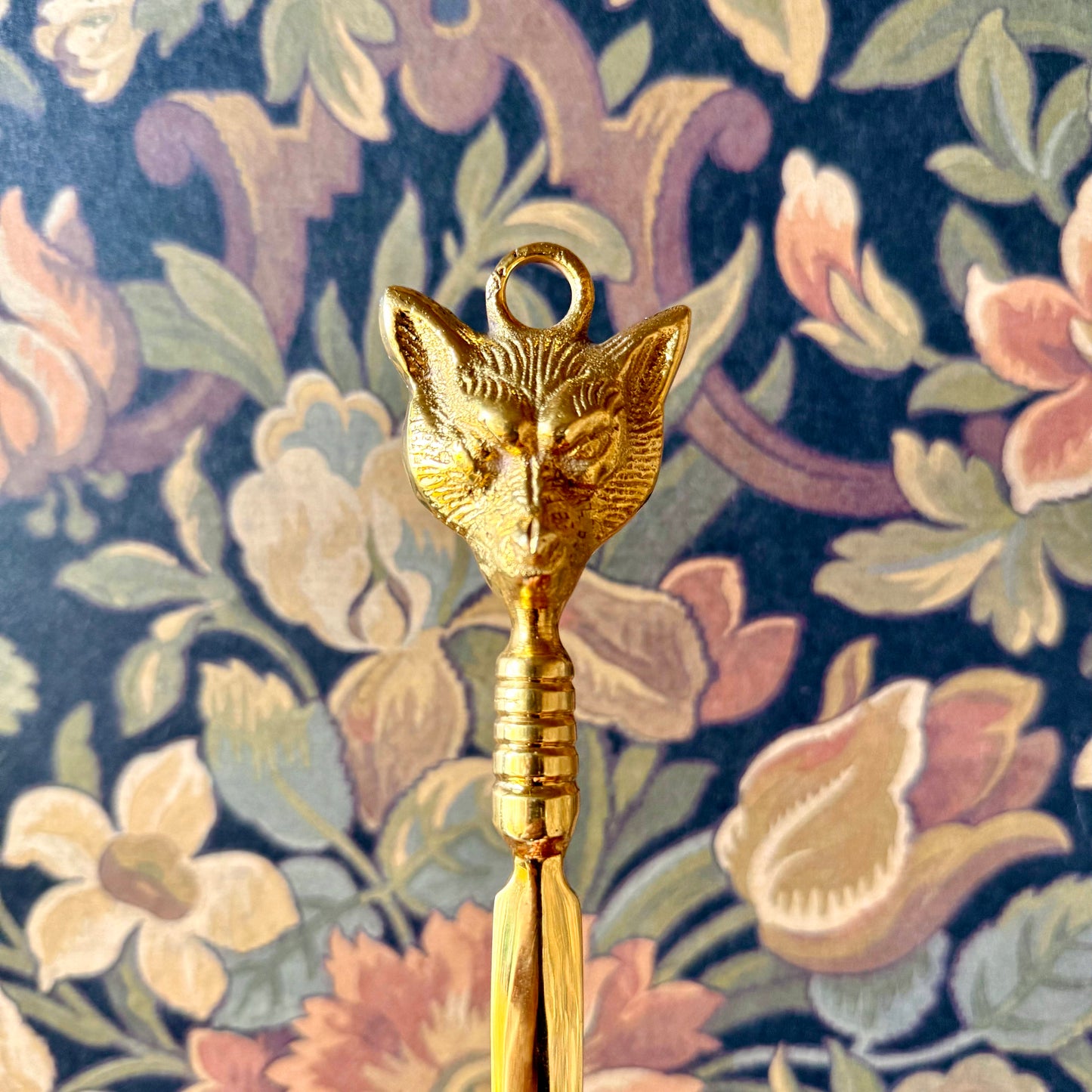 A detailed close-up of the Brass Fox Letter Opener, showcasing the intricately sculpted fox head handle and polished golden brass finish.
