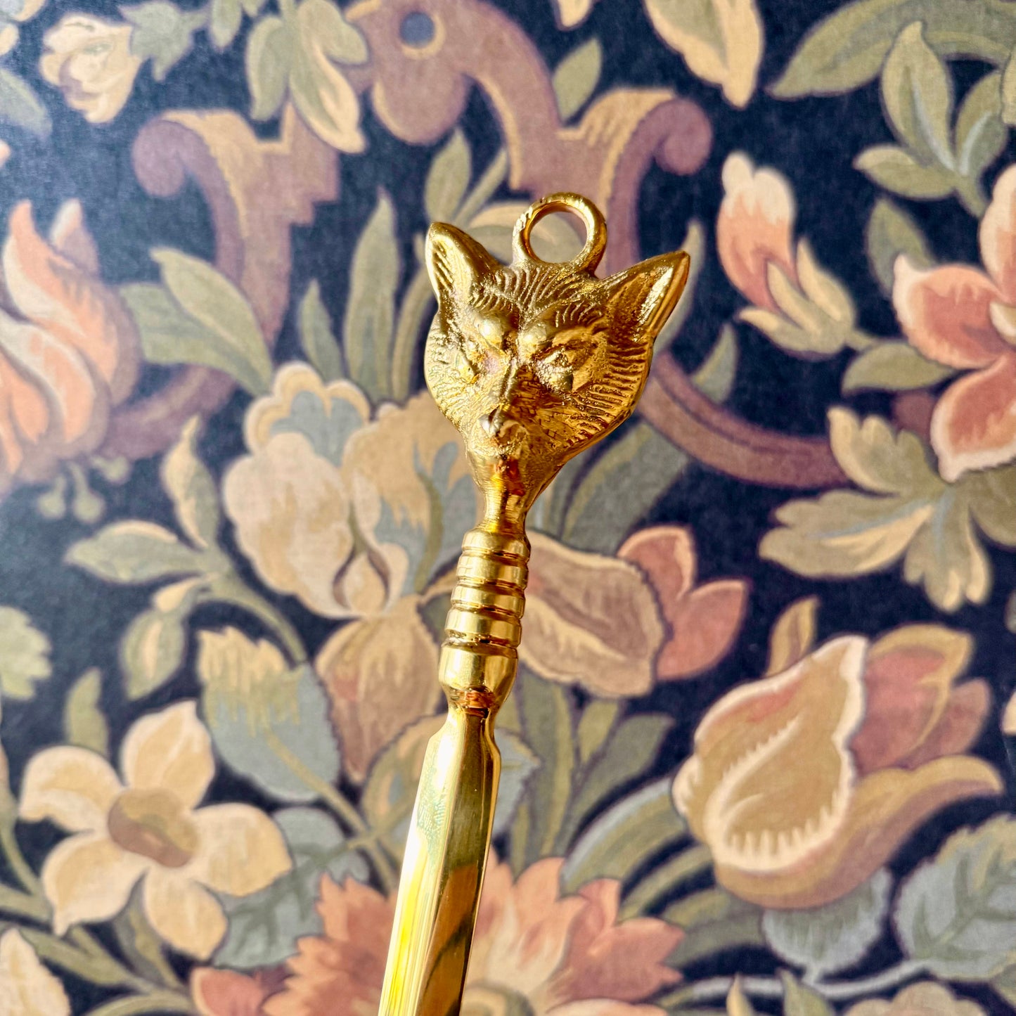A detailed close-up of the Brass Fox Letter Opener, showcasing the intricately sculpted fox head handle and polished golden brass finish.