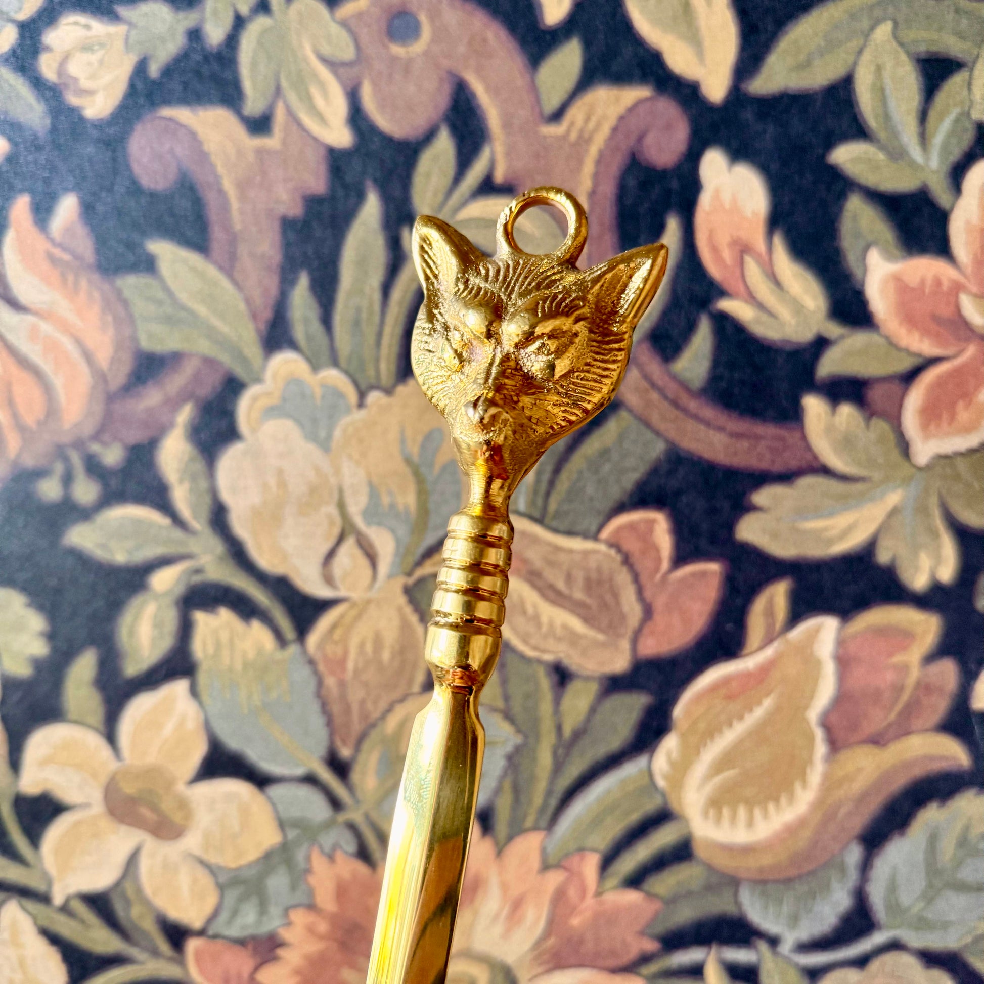 A detailed close-up of the Brass Fox Letter Opener, showcasing the intricately sculpted fox head handle and polished golden brass finish.