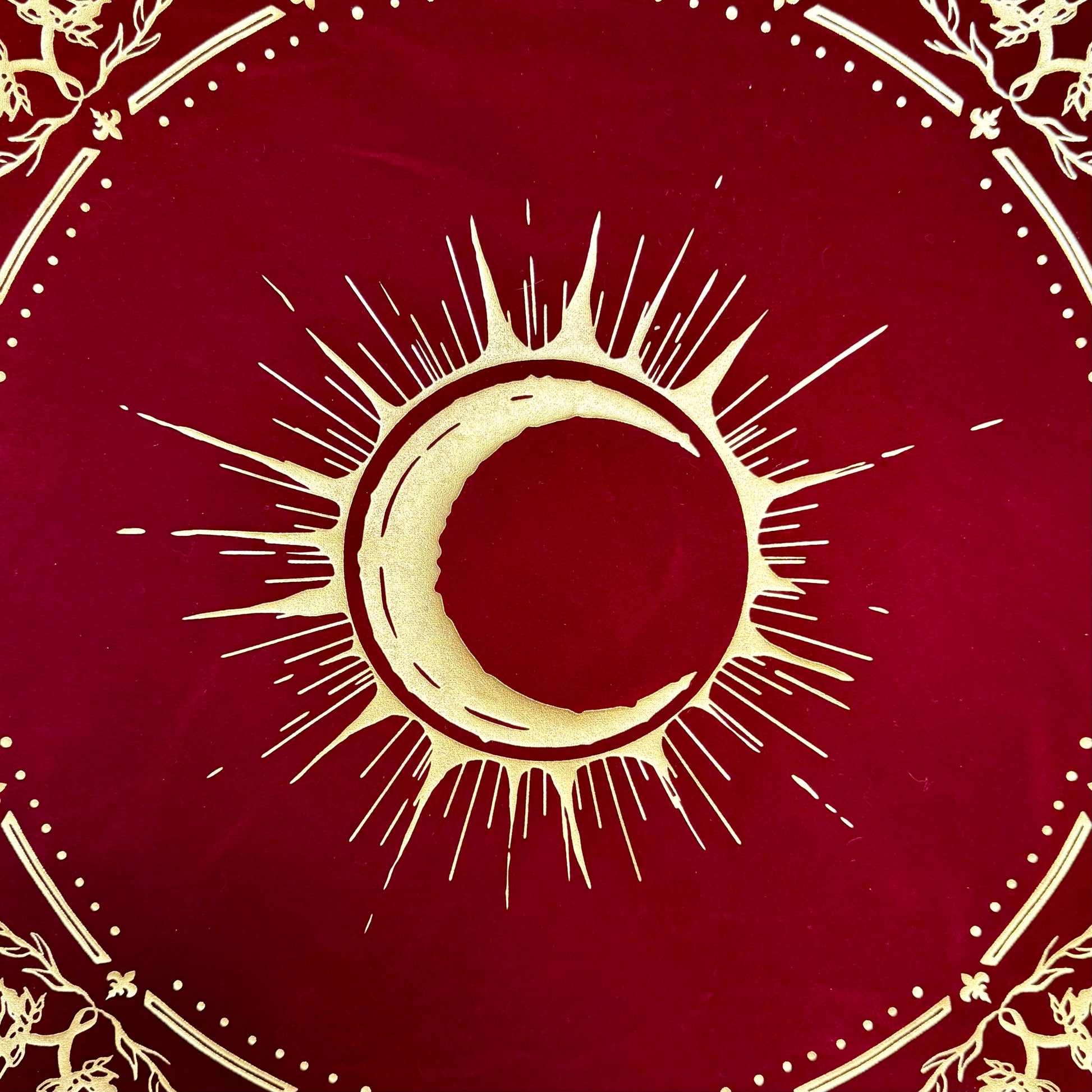 A detailed close-up of the gold foil emblem, intricately hand-stamped on the luxurious velvet fabric of the Eclipsa Altar Cloth.