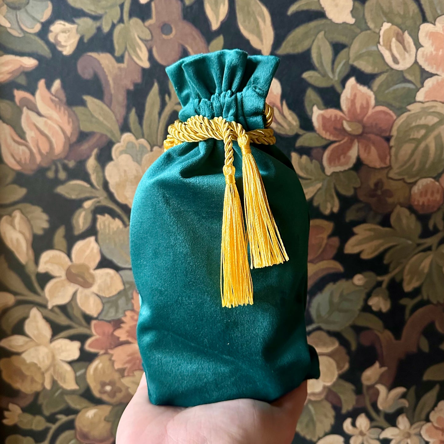 Elegant green velvet tarot bag with a gathered drawstring top, perfect for storing cards.