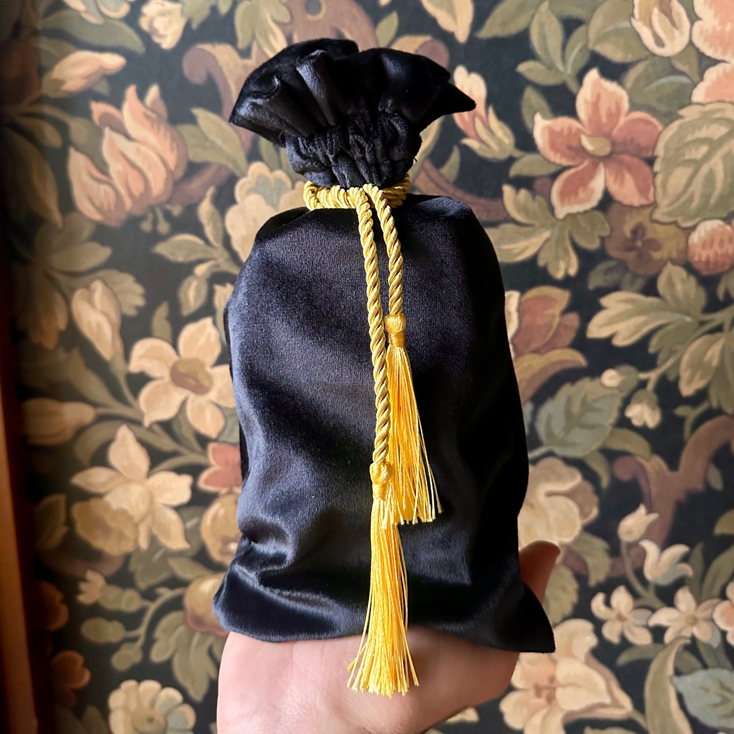 Luxurious black velvet tarot bag with a cinched drawstring, designed for tarot deck protection.