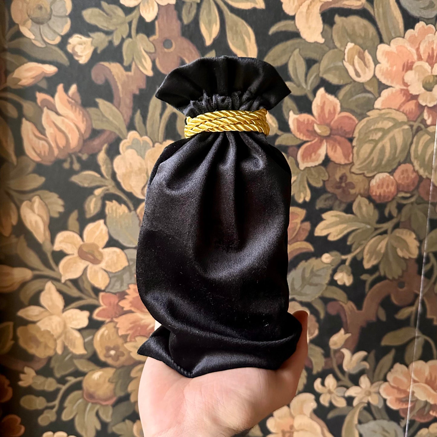 Luxurious black velvet tarot bag with a cinched drawstring, designed for tarot deck protection.