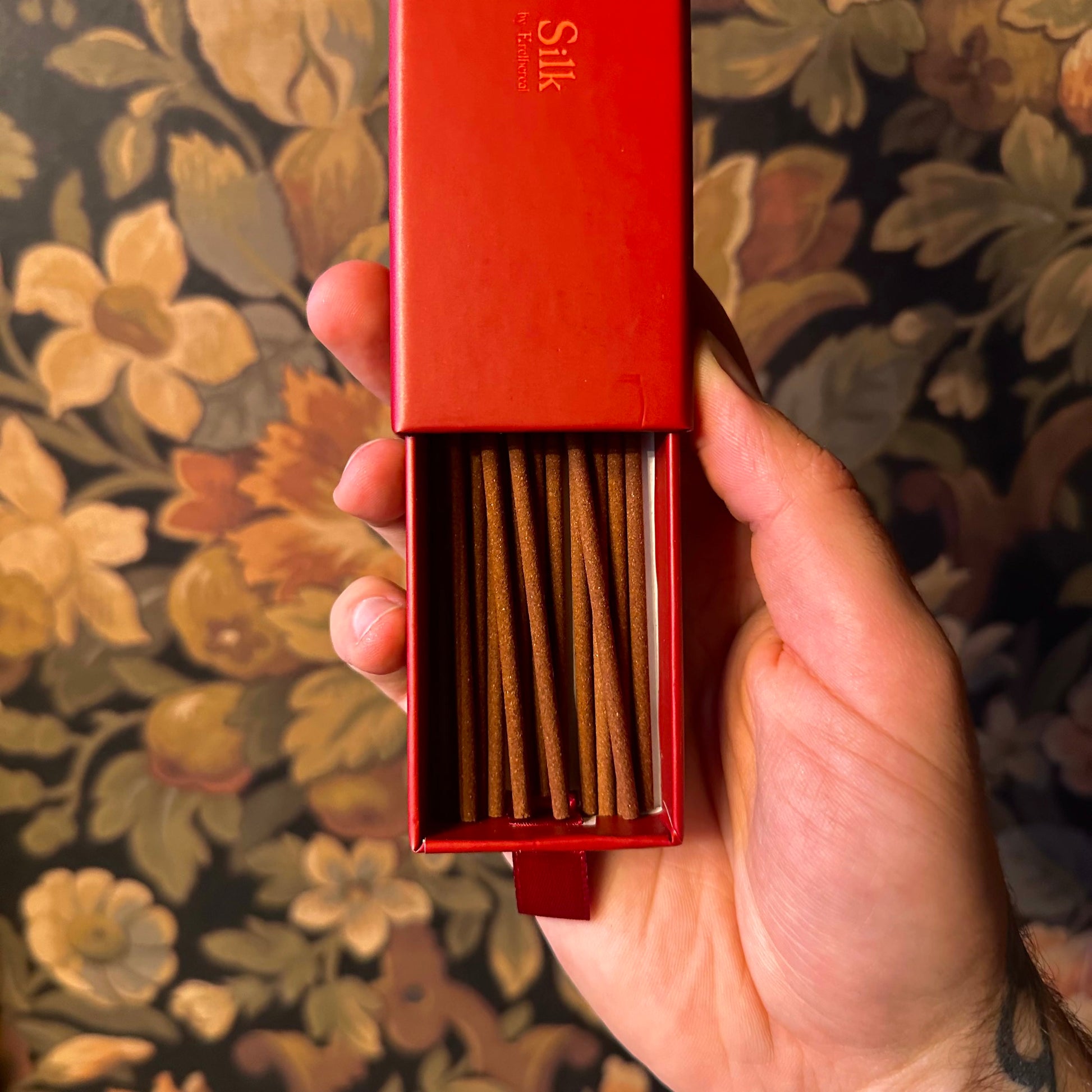 The open box reveals 15 neatly arranged Incense Batons, each slender and perfectly aligned, surrounded by a richly designed interior with a Victorian motif.