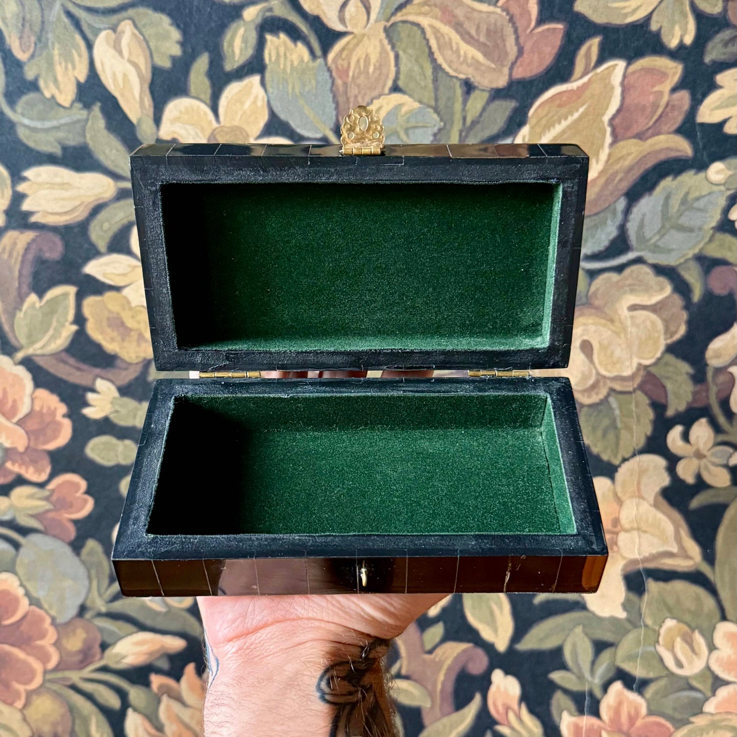 The black horn box opened to reveal a green felt-lined interior, ideal for storing jewelry, keepsakes, or tarot cards.