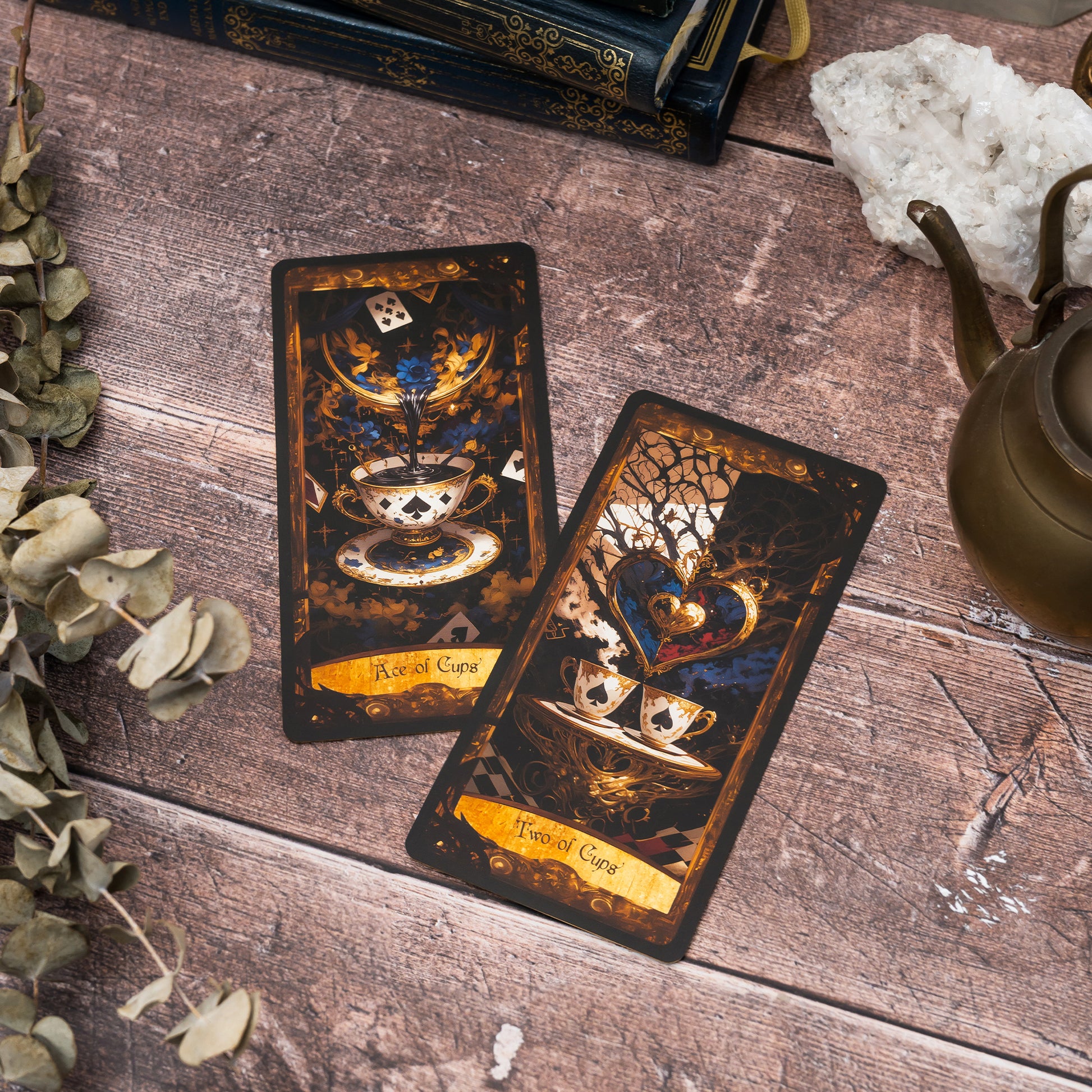 Two cards from the Suit of Cups in the Wonderland Shadows Tarot Deck, represented by ornate teacups, reflecting themes of emotion and connection with Wonderland's charm.