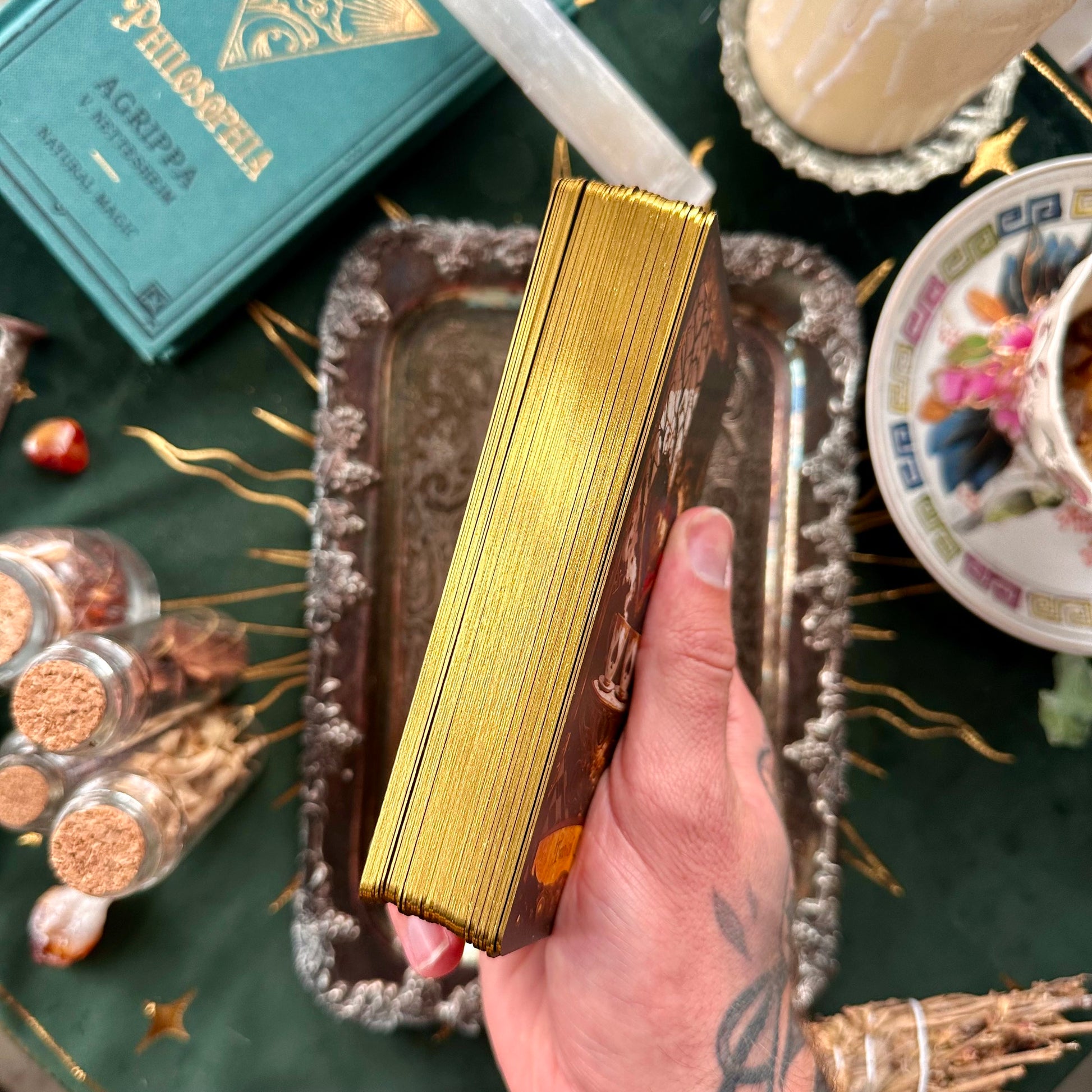 A close-up shot highlighting the shimmering gold foil edges of the tarot cards, giving the deck a luxurious, magical appearance and adding a touch of elegance to every shuffle.