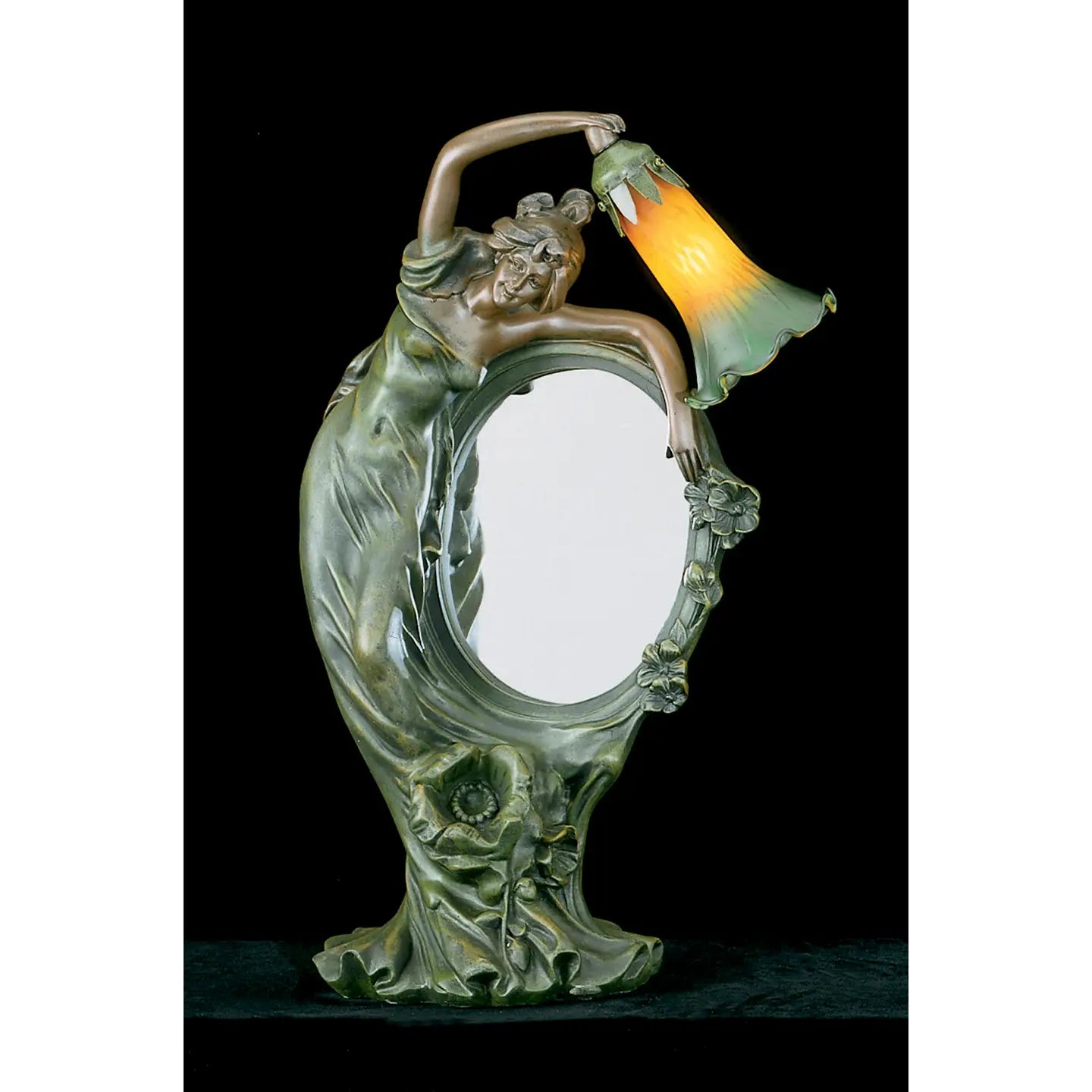 An Art Nouveau style table lamp featuring a sculpted female figure holding a bell-shaped shade that glows with a warm yellow and orange light, set against a solid black background.