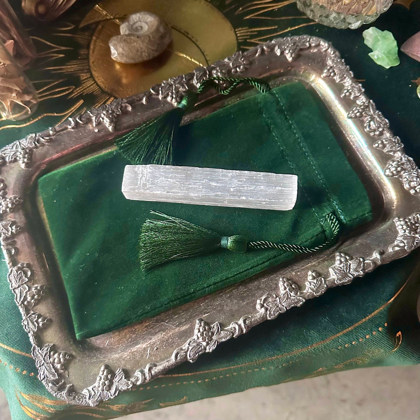 A luxurious velvet pouch in a vibrant emerald green color, measuring 4 x 7 inches. The pouch features a smooth texture and a secure drawstring closure, perfect for storing crystals, runes, or other small spiritual tools.