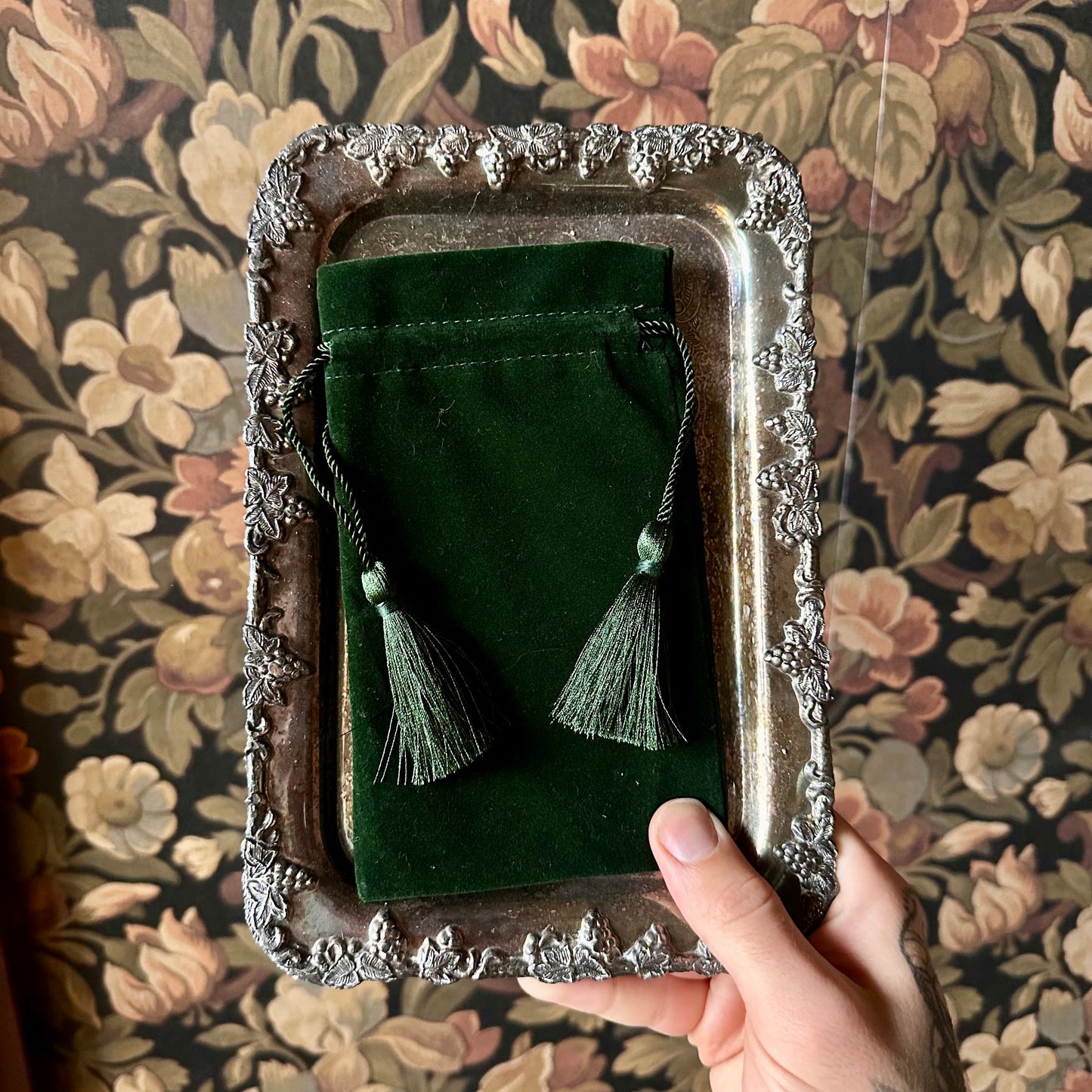 A luxurious velvet pouch in a vibrant emerald green color, measuring 4 x 7 inches. The pouch features a smooth texture and a secure drawstring closure, perfect for storing crystals, runes, or other small spiritual tools.