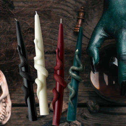Set of decorative candles with unique designs on a dark background