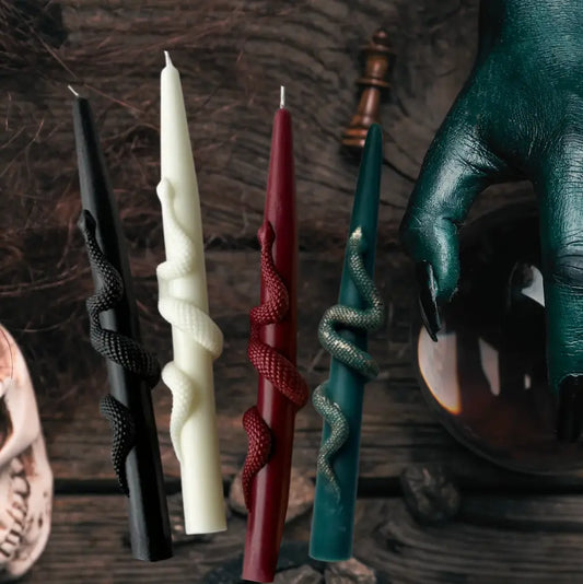 Set of decorative candles with unique designs on a dark background