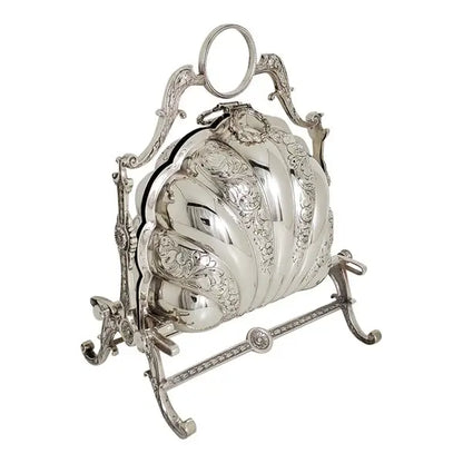 An ornate silver-toned decorative object with a ribbed, carved surface and an openwork metal stand, photographed on a plain white background.