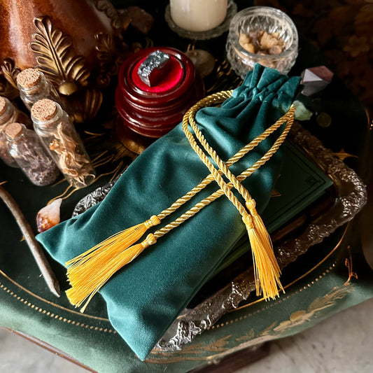 Elegant green velvet tarot bag with a gathered drawstring top, perfect for storing cards.