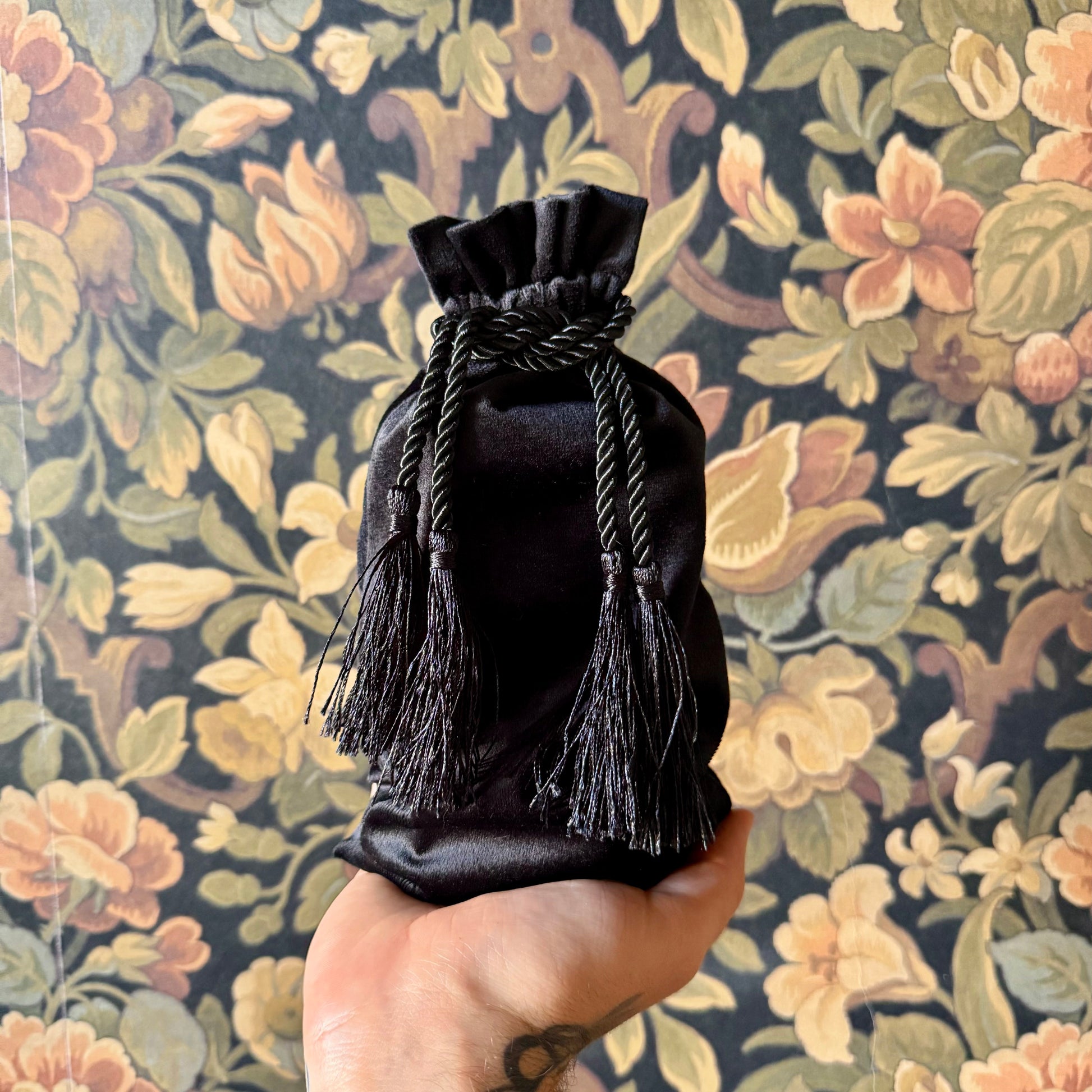 Luxurious black velvet tarot bag with a cinched drawstring, designed for tarot deck protection.