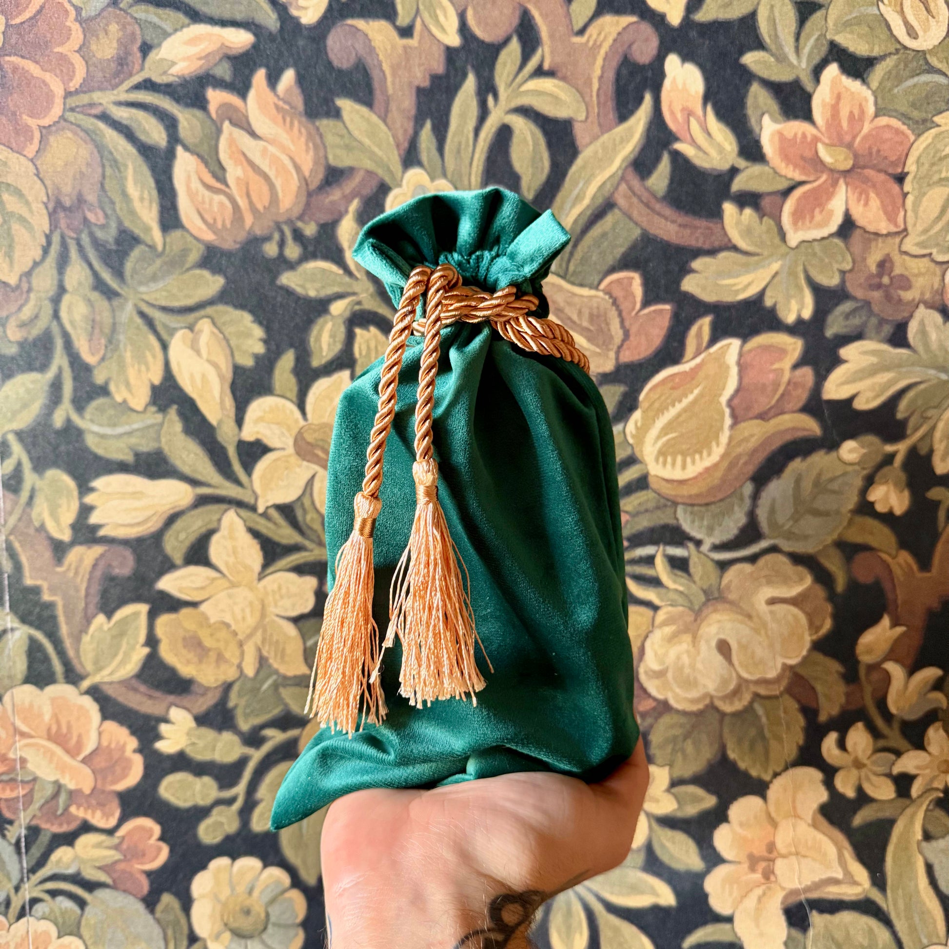 Elegant green velvet tarot bag with a gathered drawstring top, perfect for storing cards.