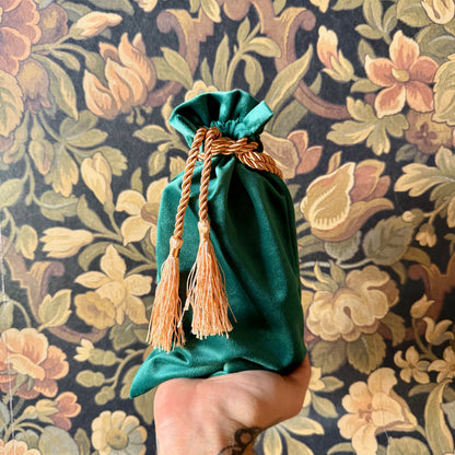Elegant green velvet tarot bag with a gathered drawstring top, perfect for storing cards.