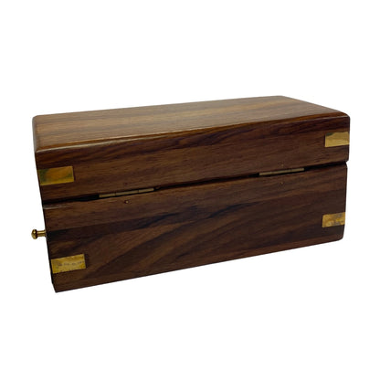 Wooden box with brass corners on a white background