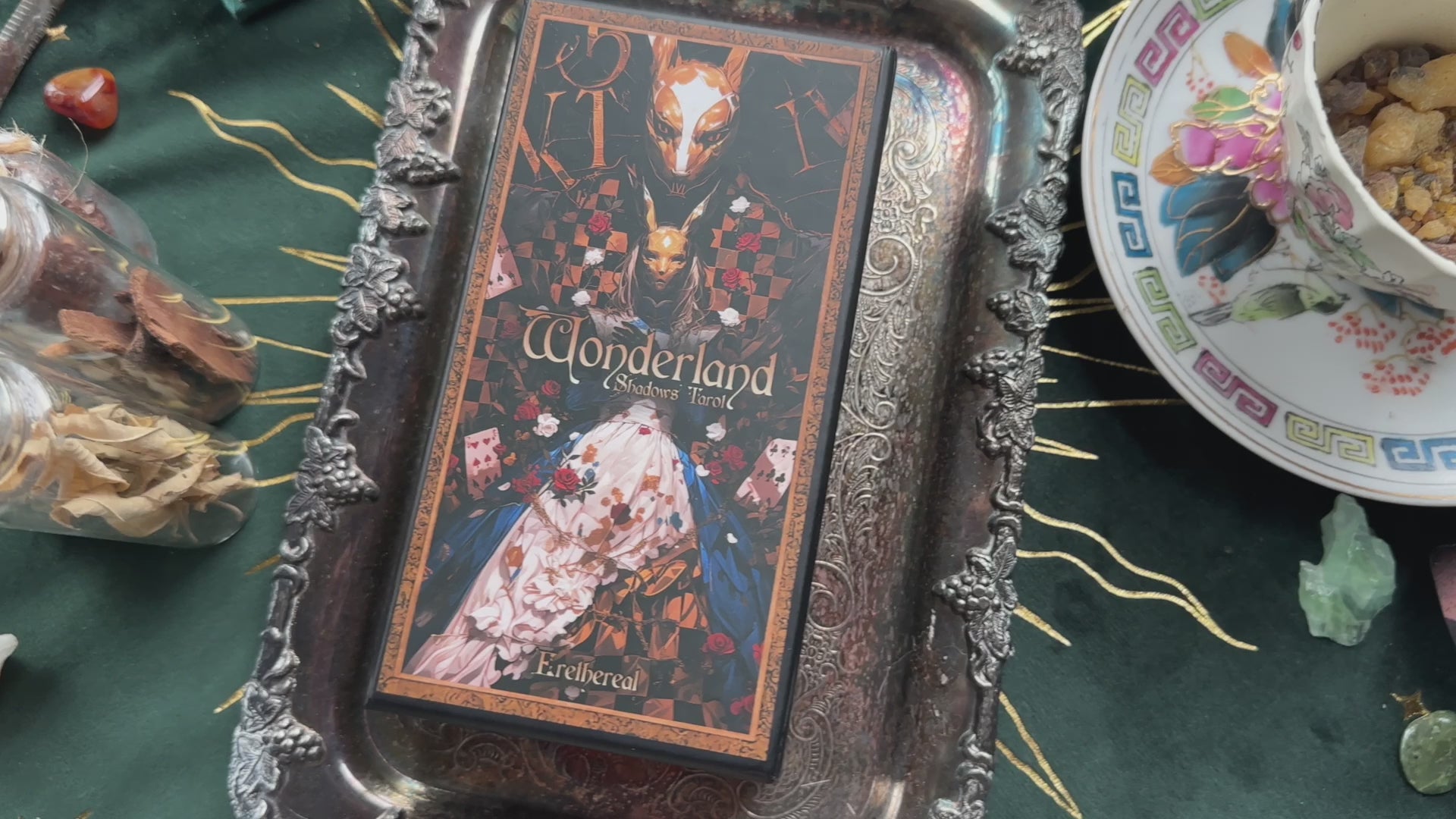 A mesmerizing video showcasing the Wonderland Shadows Tarot Deck. The camera pans across beautifully illustrated cards featuring whimsical characters from Alice in Wonderland, each card adorned with shimmering gold foil edges. Highlights include The Fool (Alice falling into the rabbit hole), The High Priestess (Cheshire Cat), and Justice (White Rabbit). The deck is presented in an elegant, sturdy box with enchanting cover art. 